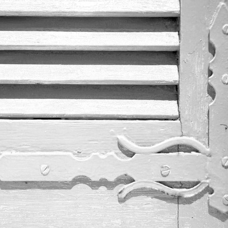 in the old wall a hinged window blue  wood and         rusty metalの写真素材