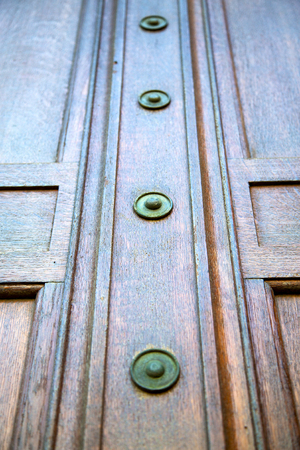 in london antique brown door  rusty  brass nail and light
