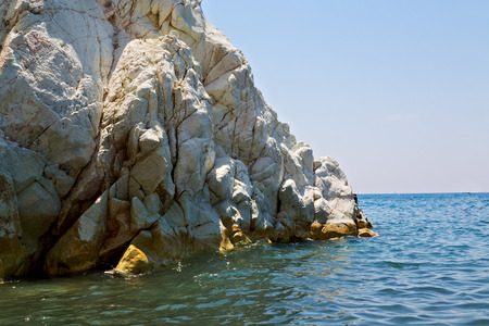 in europe greece santorini island hill and rocks on the summertime beachの写真素材