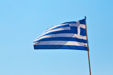 waving greece flag  in the   blue sky and      flagpoleの写真素材