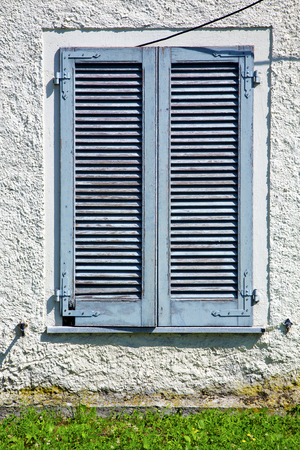 grey window  viladosia  palaces italy   abstract  sunny day    wood venetian blind in the concrete  brickの写真素材