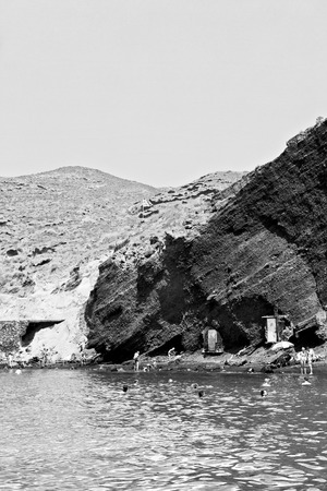 in europe greece santorini island hill and rocks on the summertime beachの写真素材