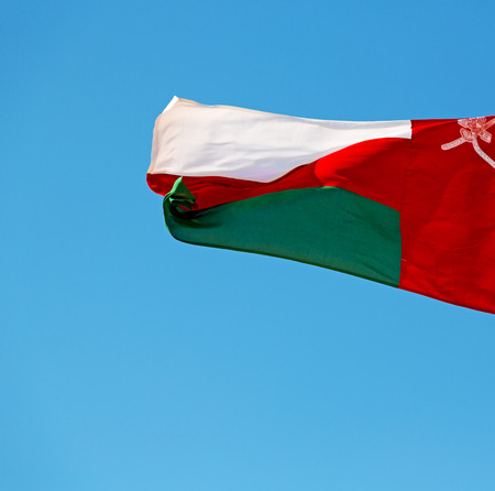 and the cloudy sky in oman waving flagの写真素材