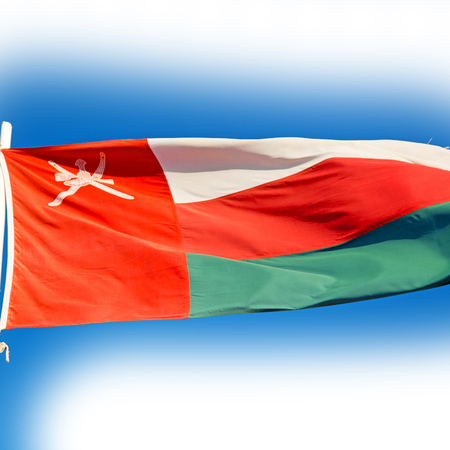 and the cloudy sky in oman waving flagの写真素材