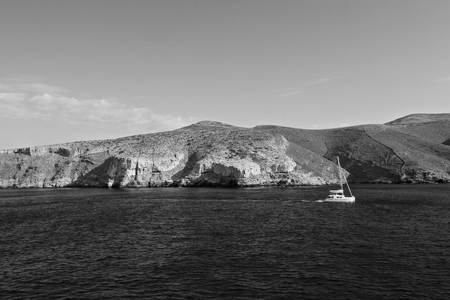 sailing in europe greece santorini island hill  and rocks on the summertime beachの写真素材