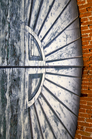the  sumirago rusty brass brown knocker in a  door curch  closed wood italy  lombardyの写真素材