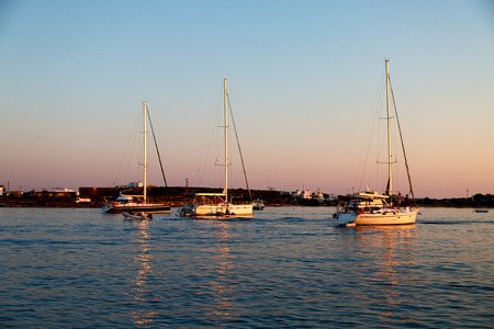 in greece near the coastline boat and yacht and sunrise light