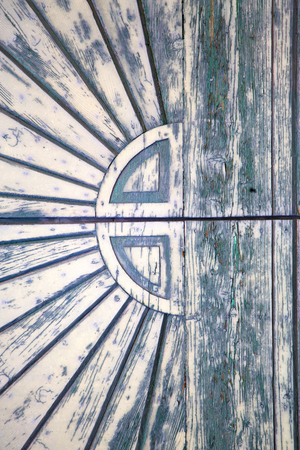 abstract cross   brass brown knocker in a   closed wood door   varese italy sumiragoのeditorial素材