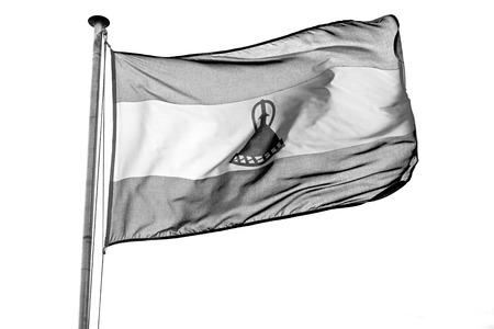 blur  in lesotho waving national flag in the cloudy skyの写真素材