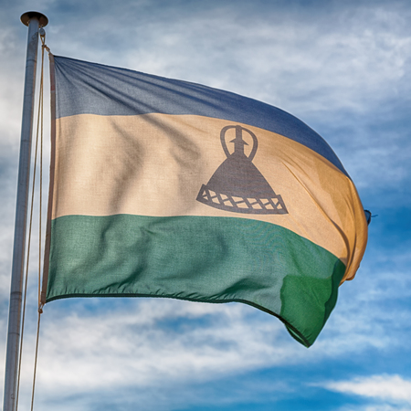 blur  in lesotho waving national flag in the cloudy skyの写真素材