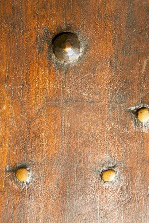 in a the mozzate rusty brass brown knocker   door curch  closed wood italy  lombardyの写真素材