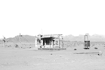 in iran old gas station  the desert mountain background and nobody