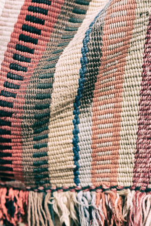 abstract texture of a colorful blanket patchwork like backgroundの写真素材