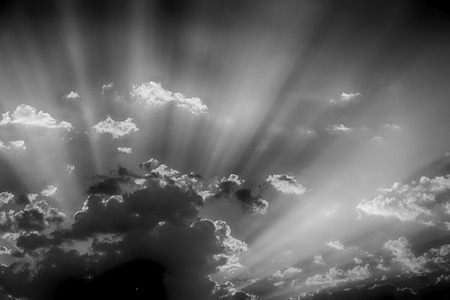 in the empty sky lots of clouds and sunny ray of lightの写真素材