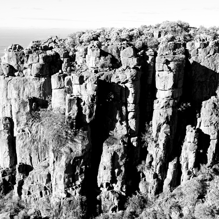 blur   in south africa valley of desolation dirty road rock tree and skyの写真素材