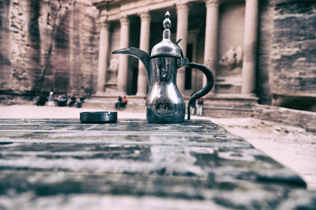 in the site of petra jordan the traditional coffe container isolated on a tableの写真素材