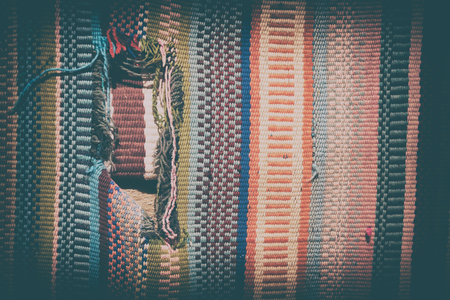 abstract texture of a colorful blanket patchwork like backgroundの写真素材