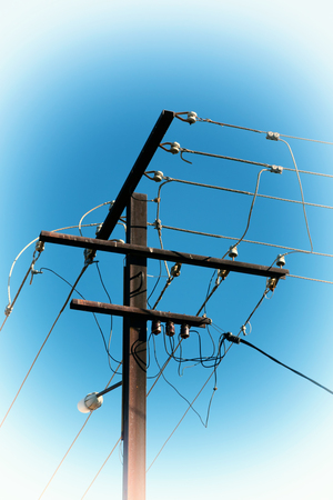 in  australia the concept of power line with electrical pole in the clear sky