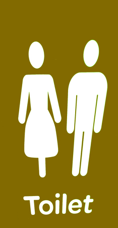 the door of the restroom and the sign for the directionの写真素材