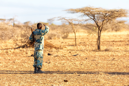 africa  in the land of ethiopia a black soldier and his gun looking the boarderの写真素材