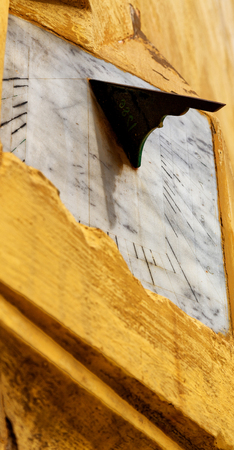 and the gnomon in the antique broken wallの写真素材