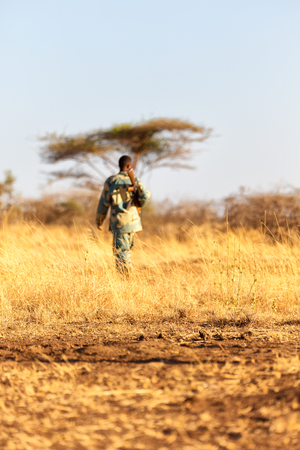 blurred  africa  in the land of ethiopia a black soldier  and his gun looking the boarderの写真素材