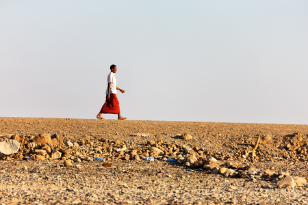 ETHIOPIA,DANAKIL-CIRCA  JANUARY 2018--unidentified  man walking in the rock desertのeditorial素材