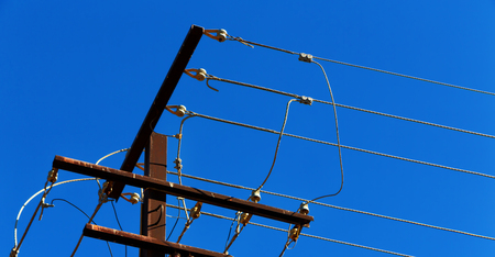 in  australia the concept of power line with electrical pole in the clear sky