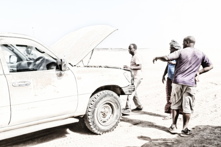 ETHIOPIA,DANAKIL-CIRCA  JANUARY 2018--unidentified  people and broken car in the land of afar peopleのeditorial素材