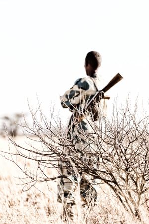 blurred africa  in the land of ethiopia a black soldier  and his gun looking the boarder