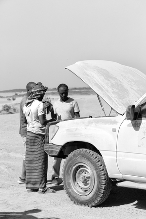 ETHIOPIA,DANAKIL-CIRCA  JANUARY 2018--unidentified  people and broken car in the land of afar peopleのeditorial素材