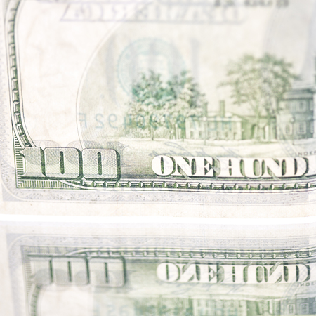 blurred dollar money background and mirror like concept of success prosperity and business
