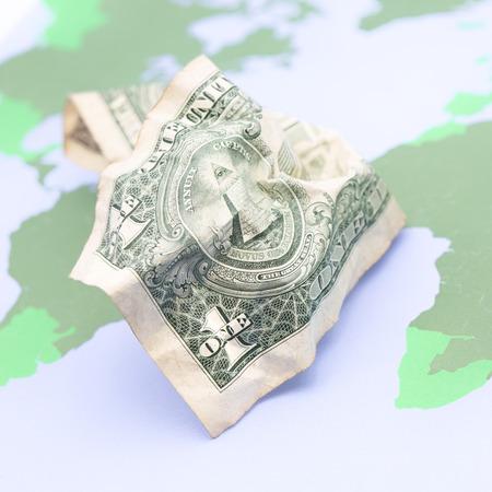 blurred   money in the world map  background like concept of buy the planet with dollarsの写真素材