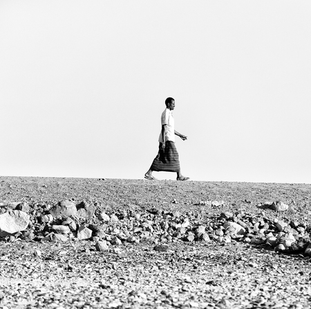 ETHIOPIA,DANAKIL-CIRCA  JANUARY 2018--unidentified  man walking in the rock desertのeditorial素材