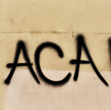 in the old wall the painted words of acab like concept of violence anddivisionの写真素材