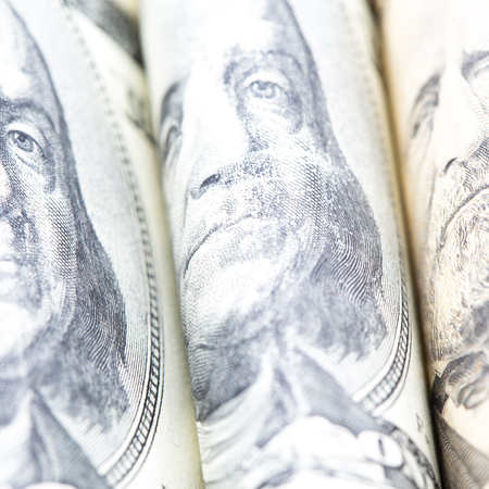 blurred dollars banknote rolled up and close up concept of economy