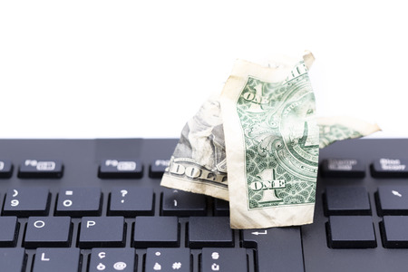 blurred crumpled dollar money background in a keyboard like concept of problem anc copy space