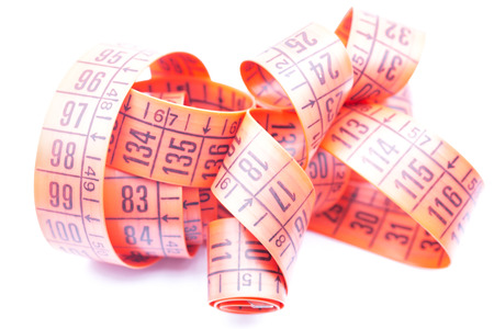 blur red  tape measure in the white light like concept of diet and lenght tool   and copy space