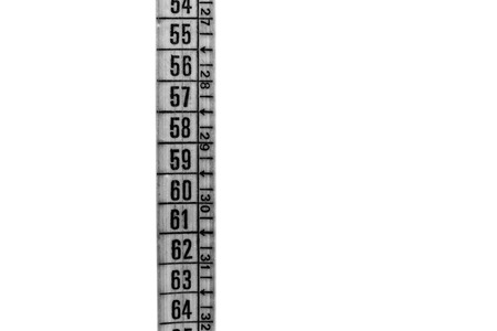 blur red  tape measure in the white light like concept of diet and lenght tool   and copy space