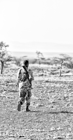 africa  in the land of ethiopia a black soldier  and his gun looking the boarder