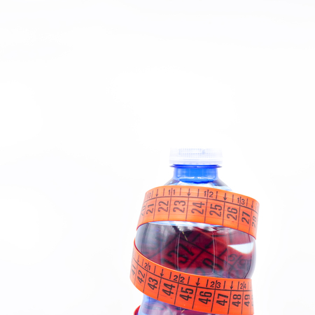 in the white light and copy space bottle of water and red measure tape like concept of lifestyle and dietの写真素材