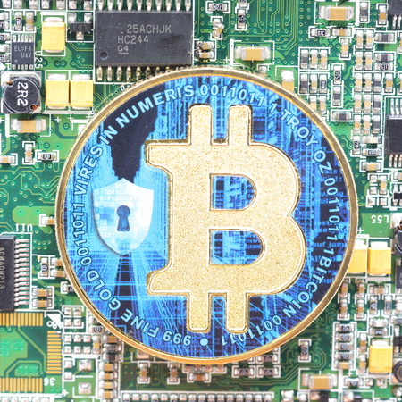 in the motherboard of a computer the coin of bitcoin like concept of future and investmentの写真素材