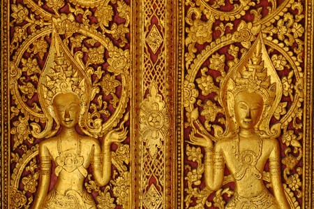 Traditional laos style door of Buddhist churchの写真素材