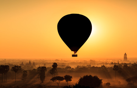 Hot air balloon over plain of Bagan in misty morning, Myanmarの写真素材