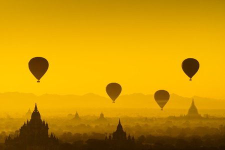 Hot air balloon over plain of Bagan in misty morning, Myanmarの写真素材