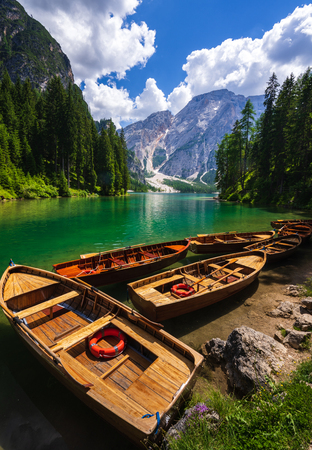 Wooden boat at lake Braies, Dolomites mountains, Italyの写真素材