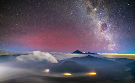 Bromo volcano with milky way, the moon and sand strom Tengger Semeru national park, East Java, Indonesiaの写真素材