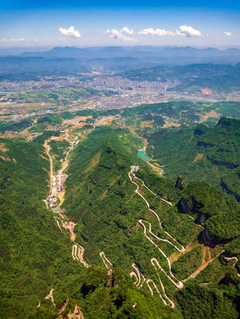 Aerial view of tianmen city with curve road to the mountain, Chinaの写真素材