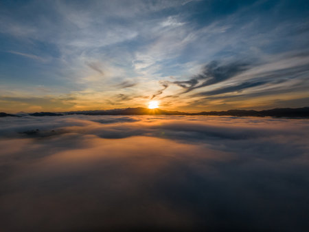 Aerial view drone flying over sea of fog at sunrise, Khoa Khai nui mountain, Phang Nga, Thailandの写真素材