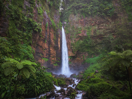 Aerial drone view of Kapas Biru waterfall in deep forest of Lumajang, East Java, Indonesiaの写真素材